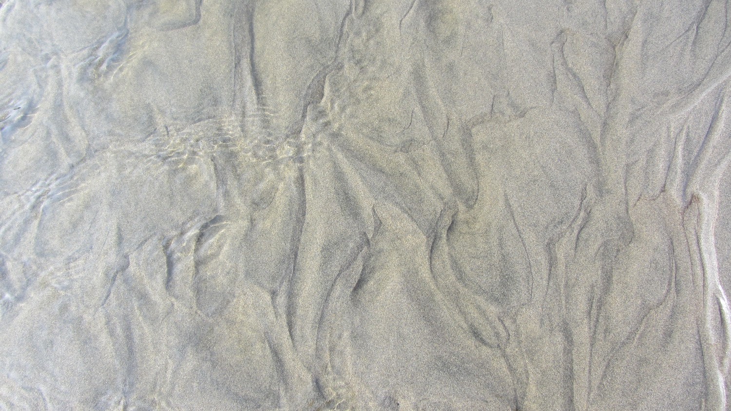 Patterns in the sand of the Huevil Beach
